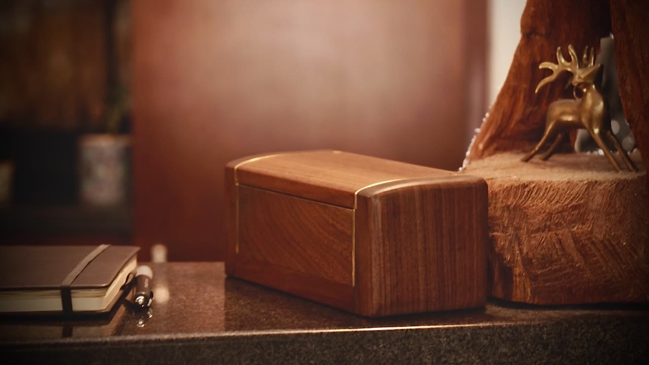 The Detox Box on a desk, brass-lined walnut, closed for off time